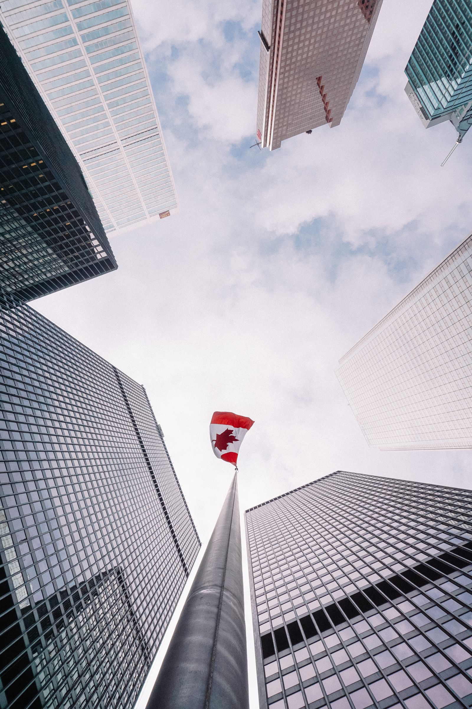 Canadian flag flying beneath office towers