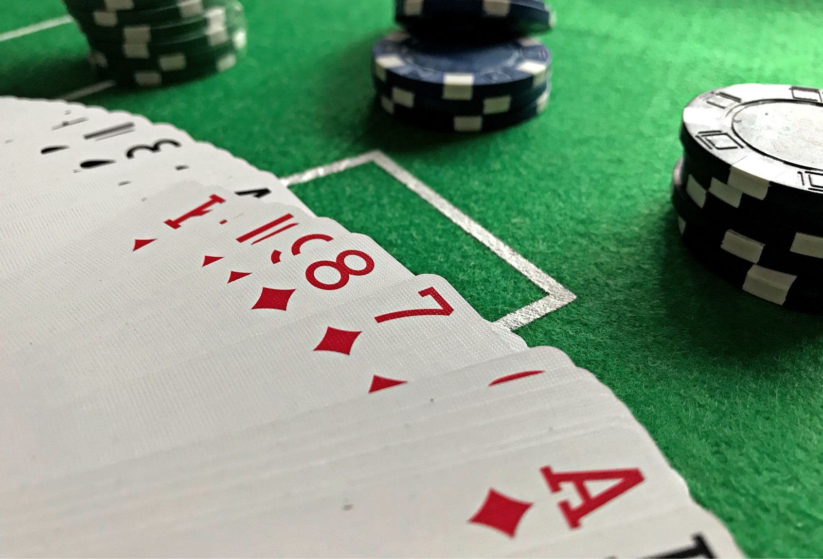 Playing cards and poker chips on a green table